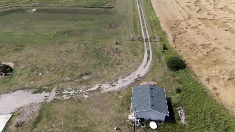Aerial view of the lane curving in toward the outbuilding